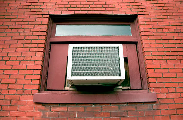 View of a window with a window air conditioner, ideal for cooling the space on hot days.
