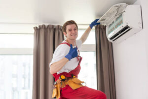 A man in overalls and safety gear repairs an air conditioner labeled 'AC Not Cooling' in a residential setting. 